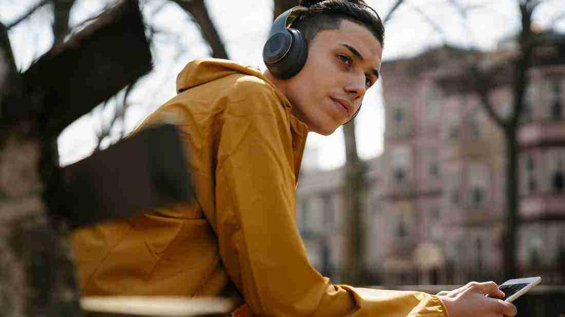 A man listening to music in the park