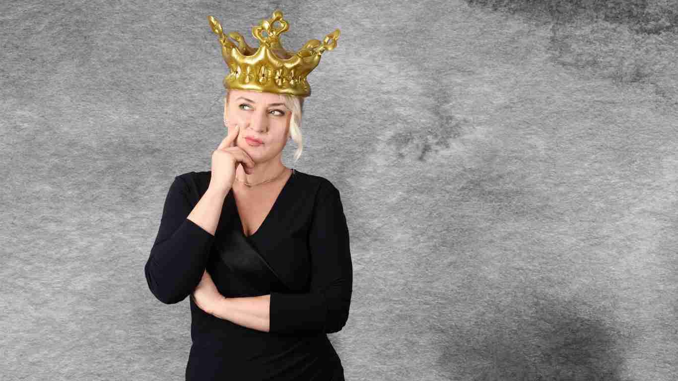A woman wearing an oversize golden crown