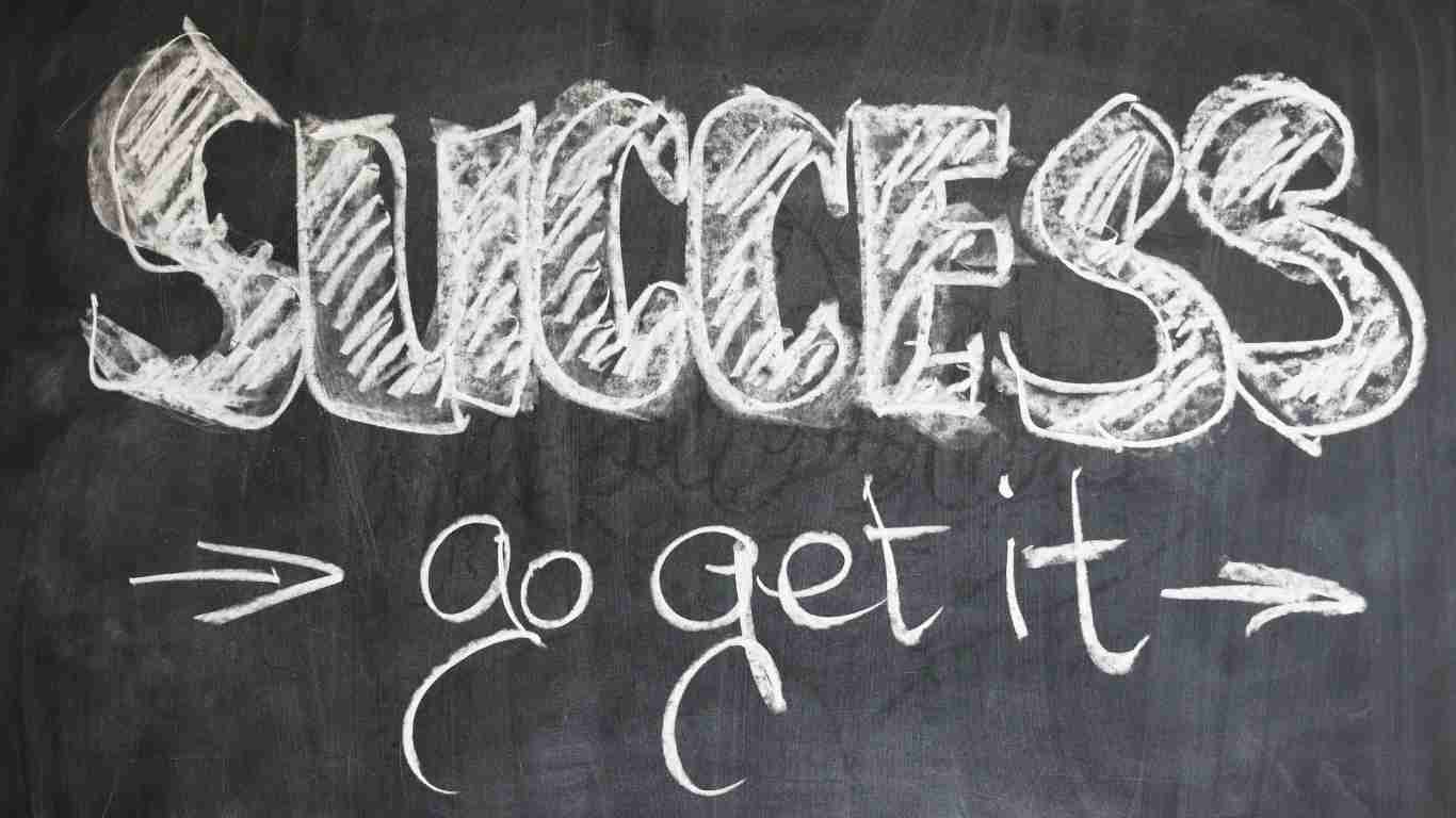 The word SUCCESS written in chalk on a black board