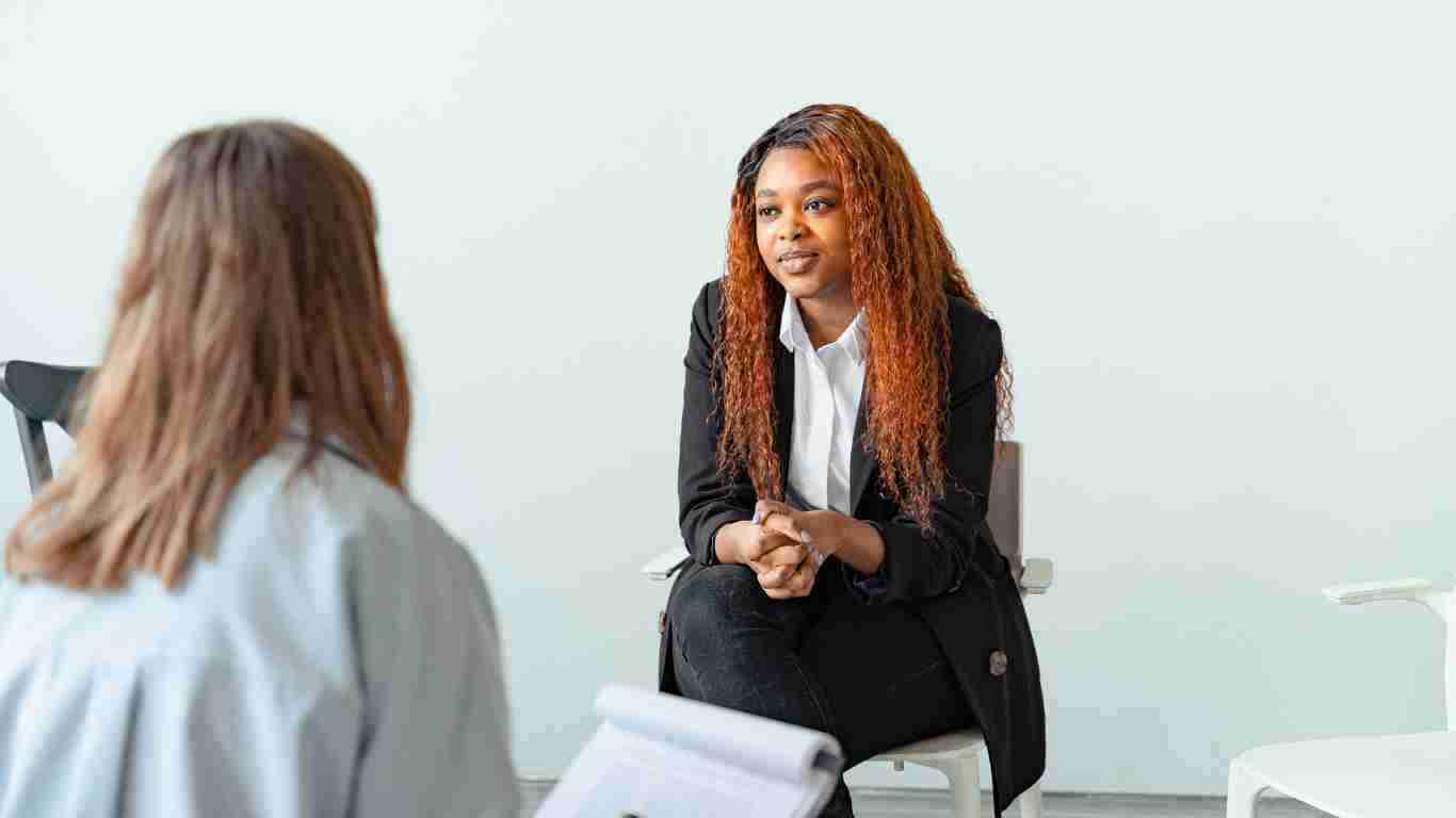 A young woman talking to her therapist
