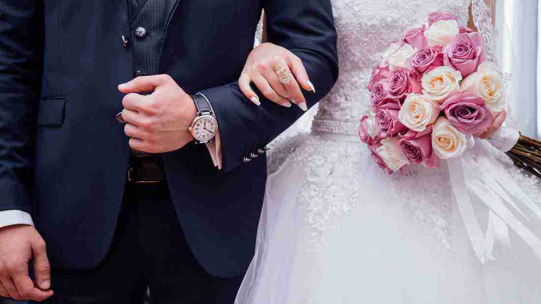 A couple arm in arm on their wedding day