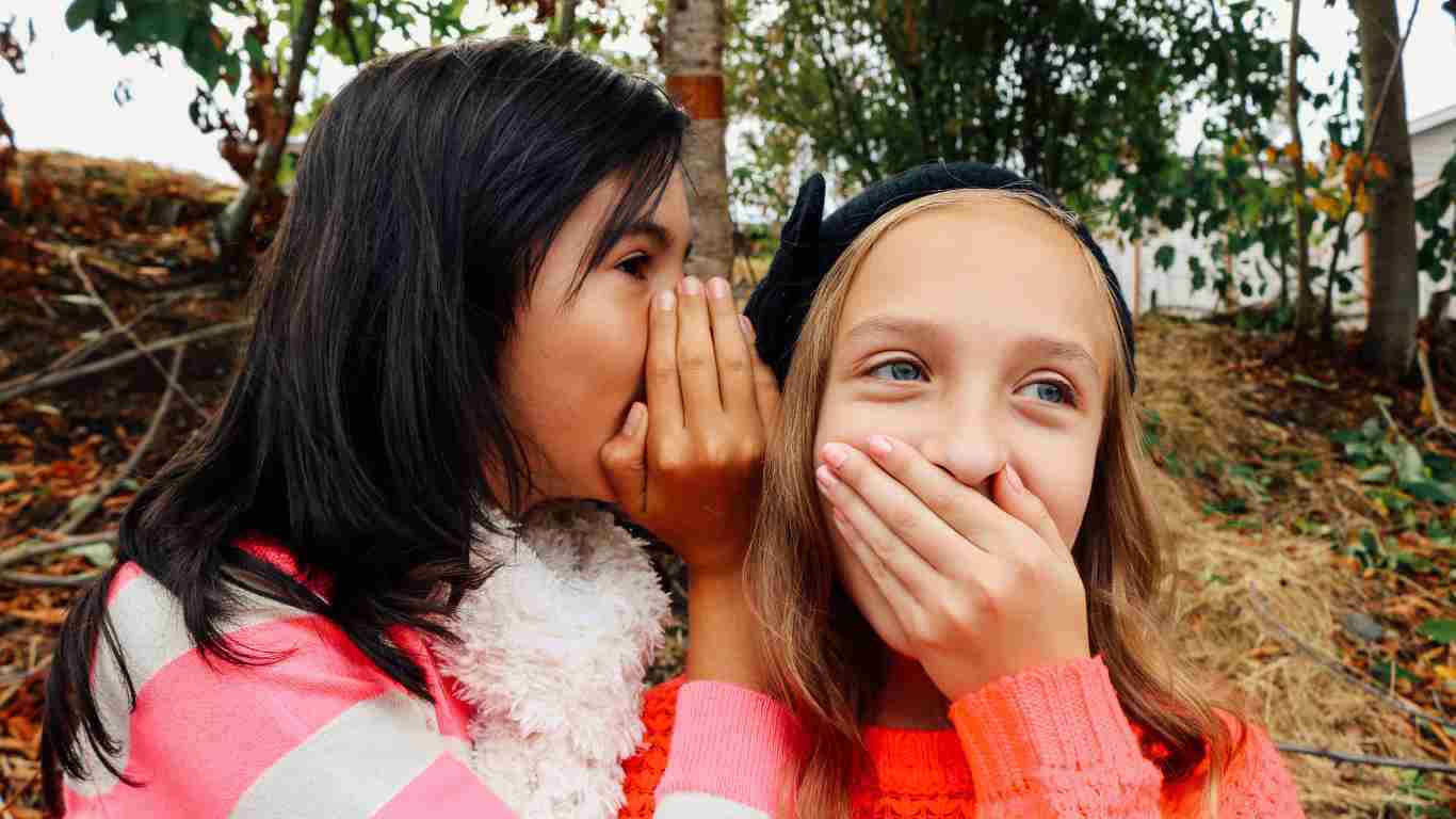Two girls gossiping and giggling