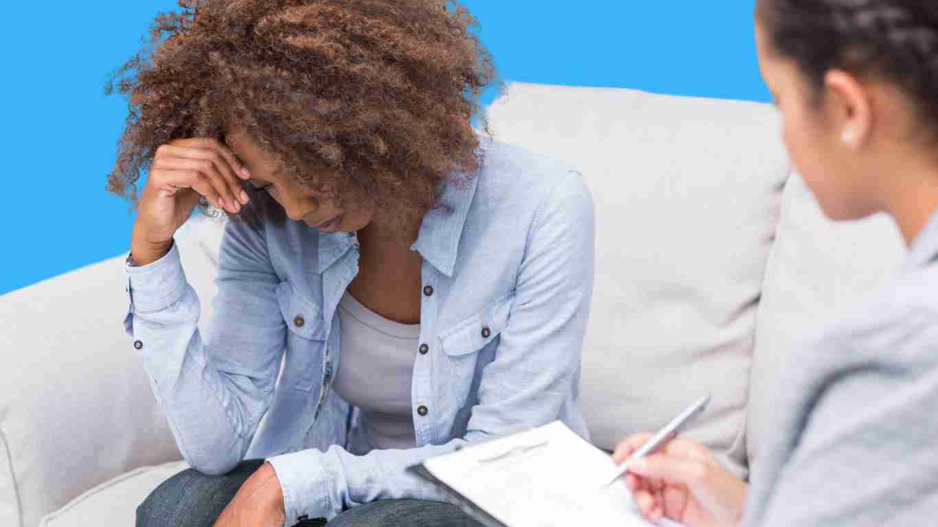 A young woman crying during a session with her therapist