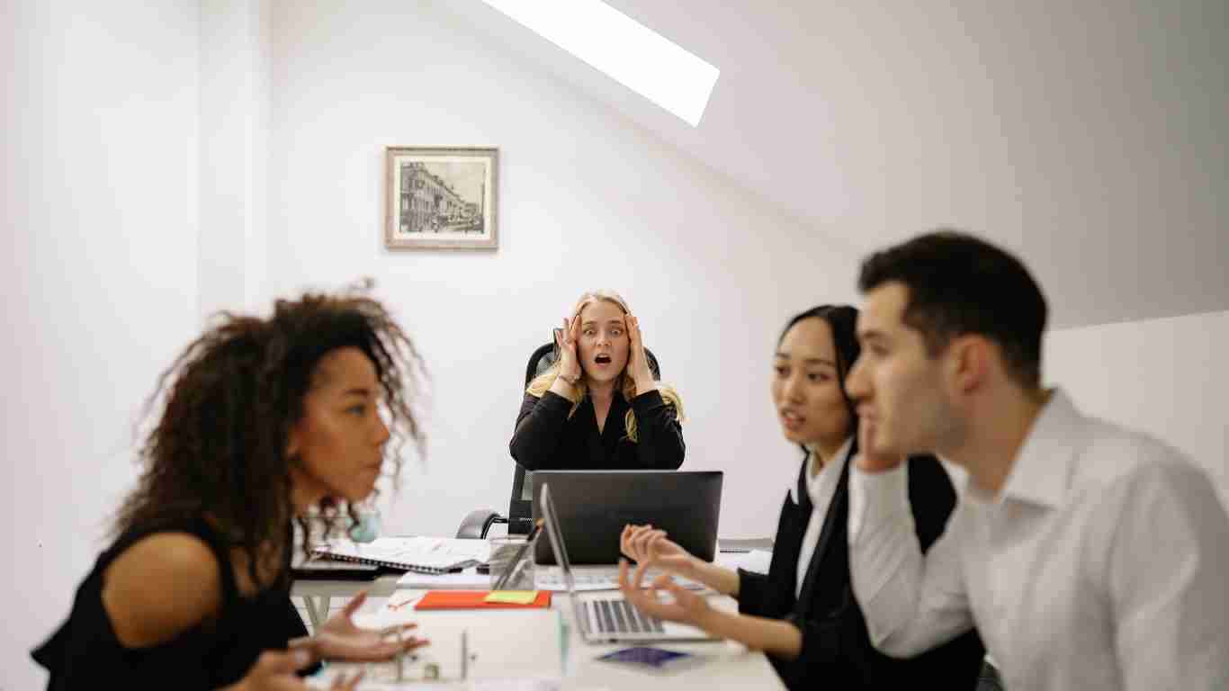 Two colleagues fighting during a work meeting