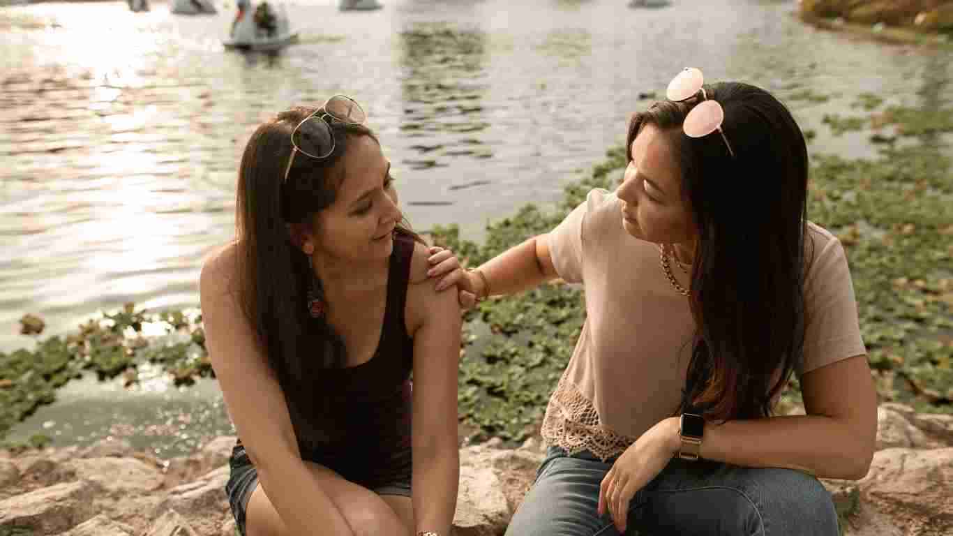 A young woman comforting her friend