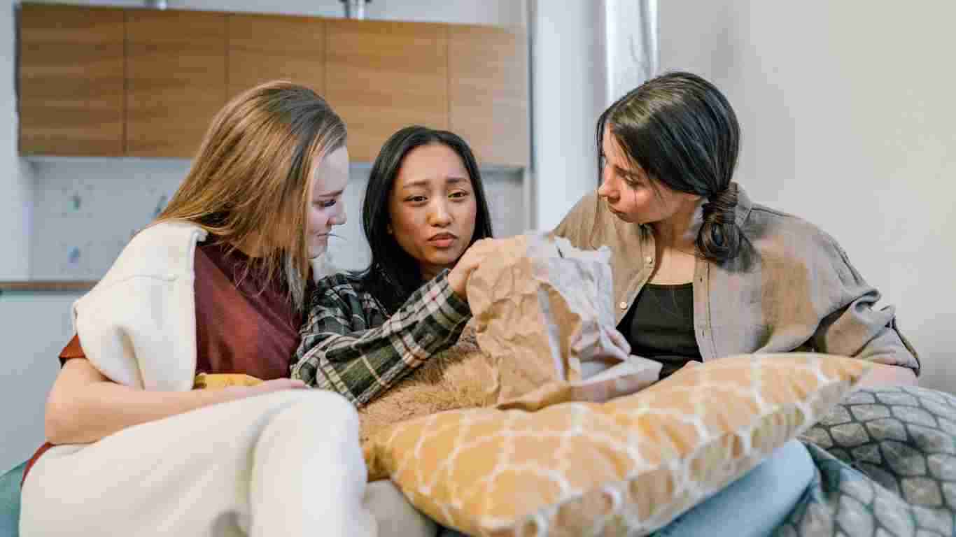 A group of woman comforting their upset friend