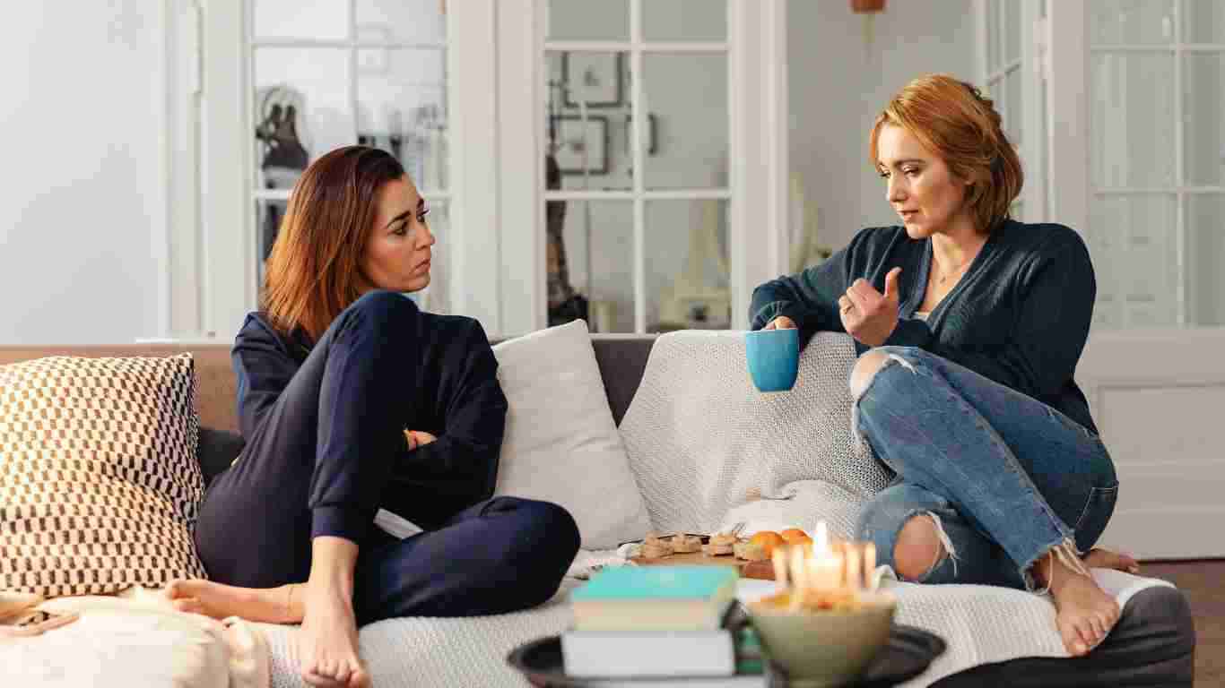 Two friends chatting on the sofa