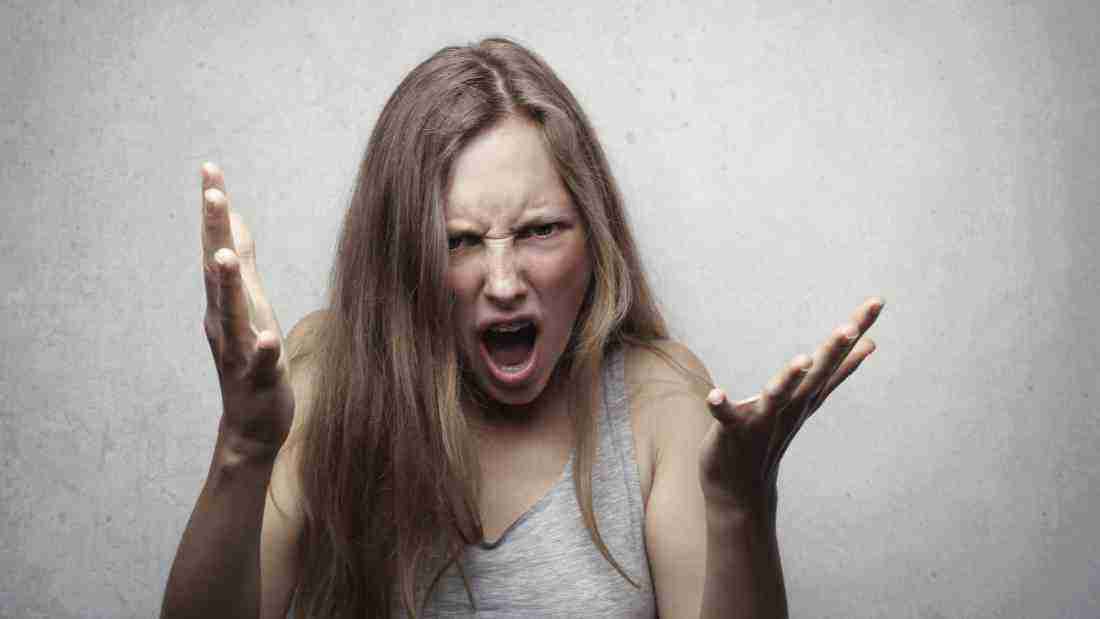 A woman screaming manically