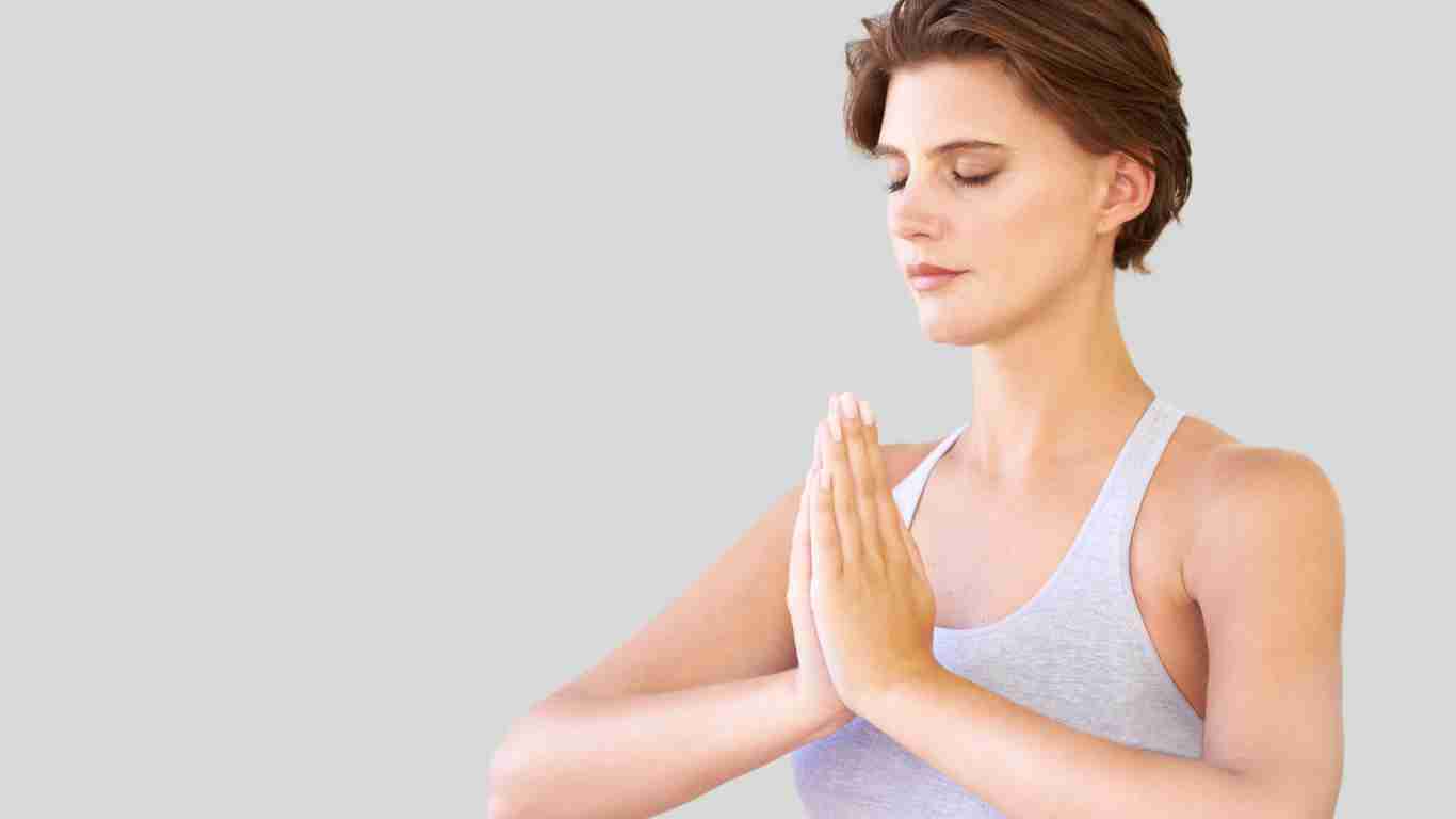A woman meditating in a peaceful setting