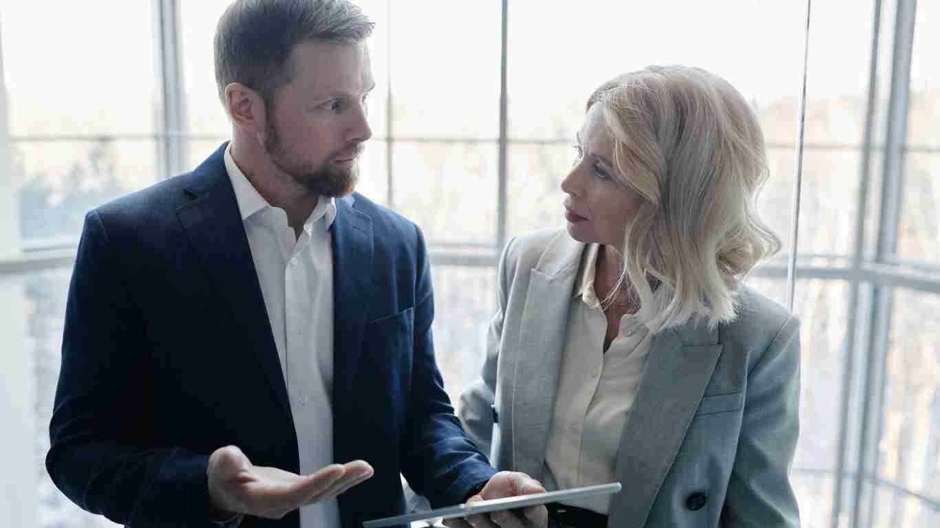Two co-workers having a serious discussion