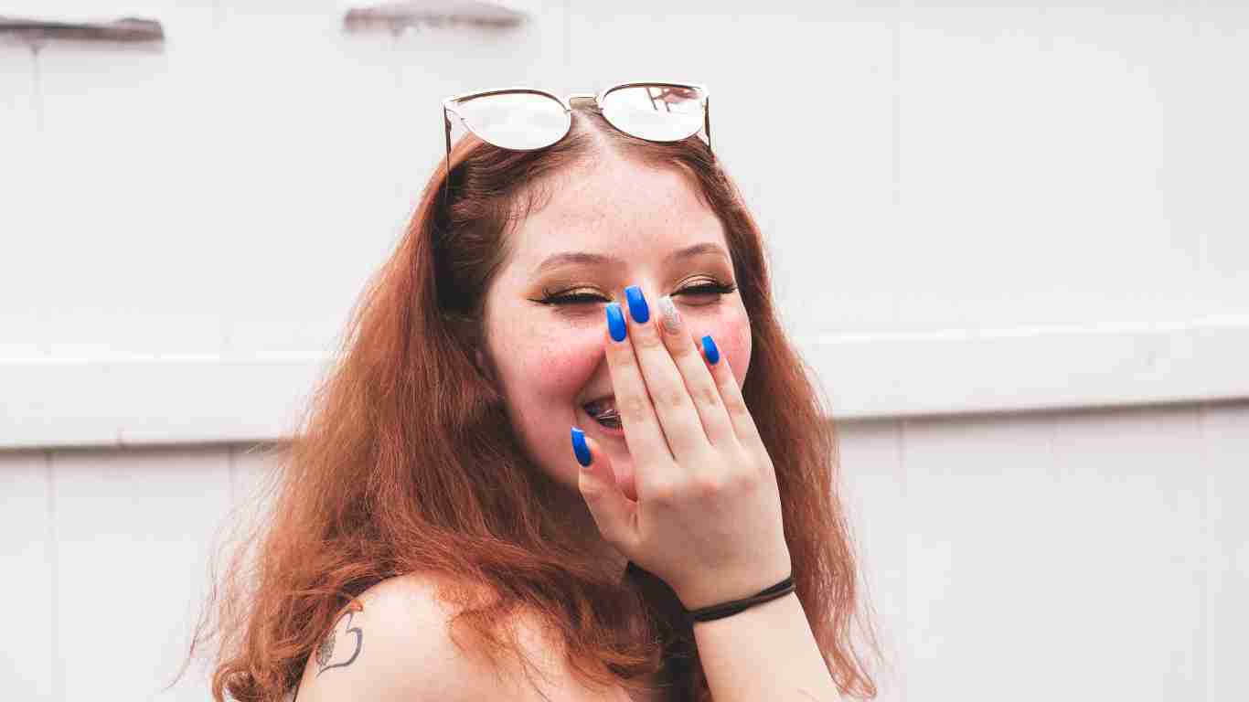 A shy woman covering her face