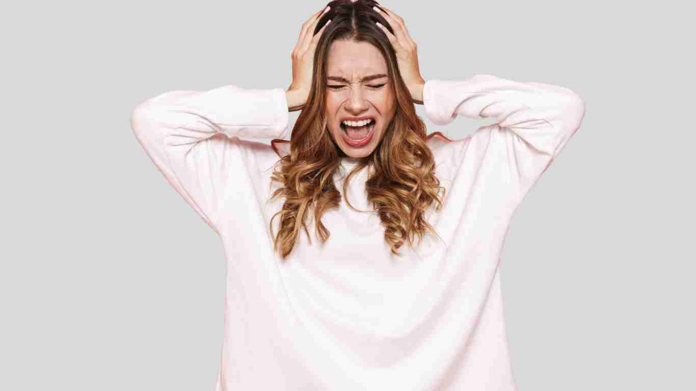 A woman who is almost tearing her hair out with stress