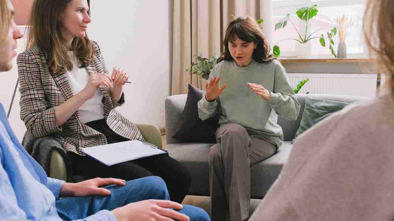A woman talking while attending a support group