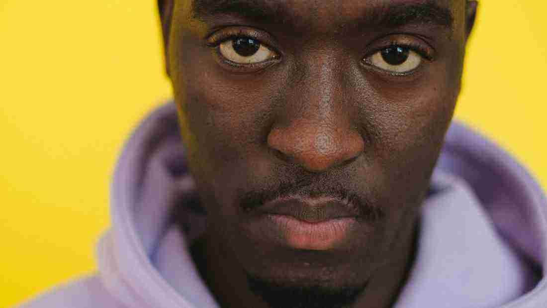 A man gazing straight into the camera, exuding arrogance