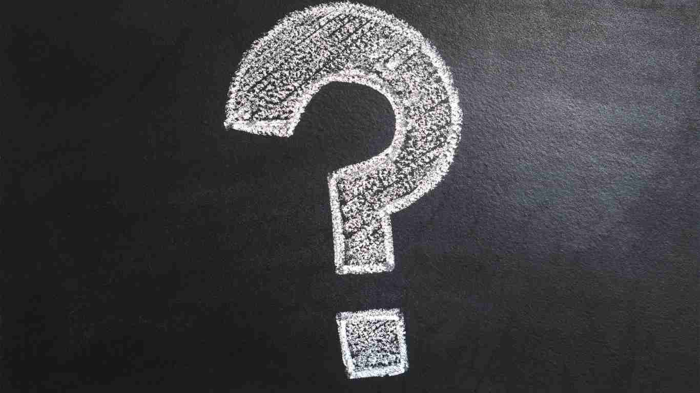 A big question mark written in chalk on a blackboard