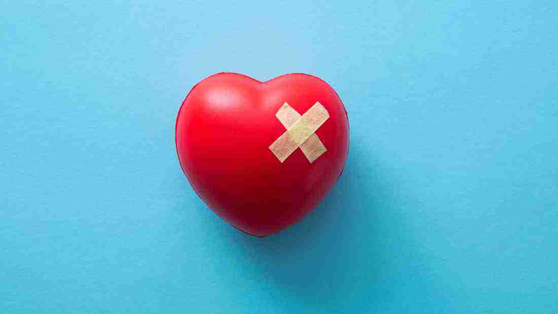A heart that is healing with plasters stuck to it's damaged bits