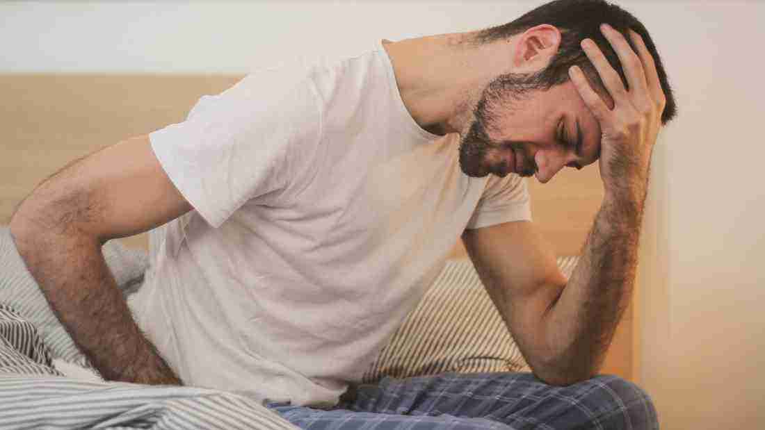 A man who is in the grips of a terrible migraine