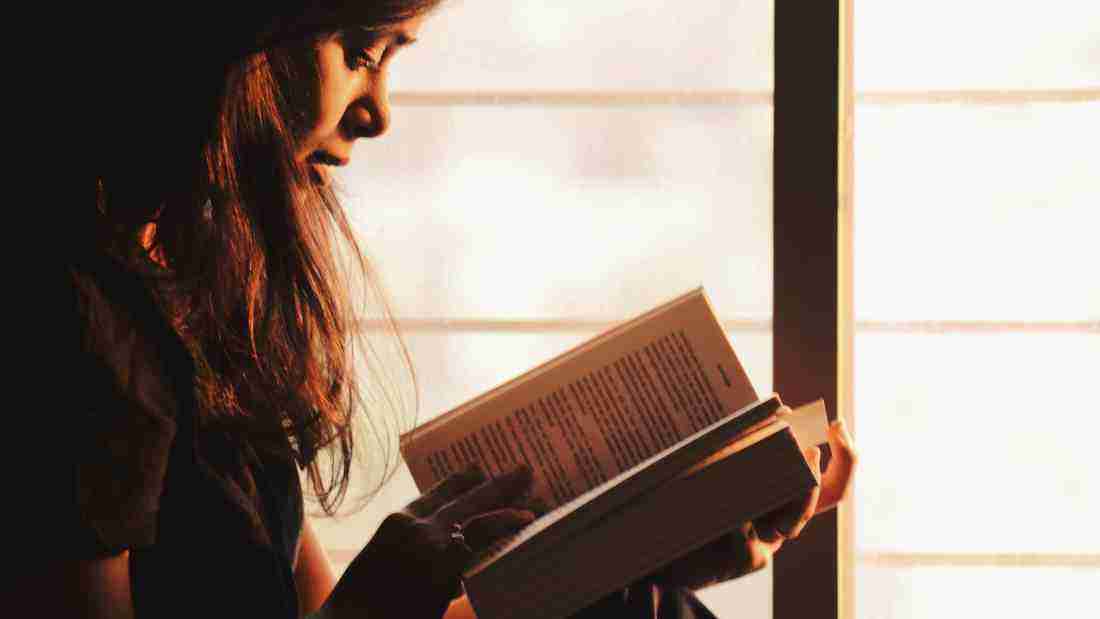 A young woman reading a book