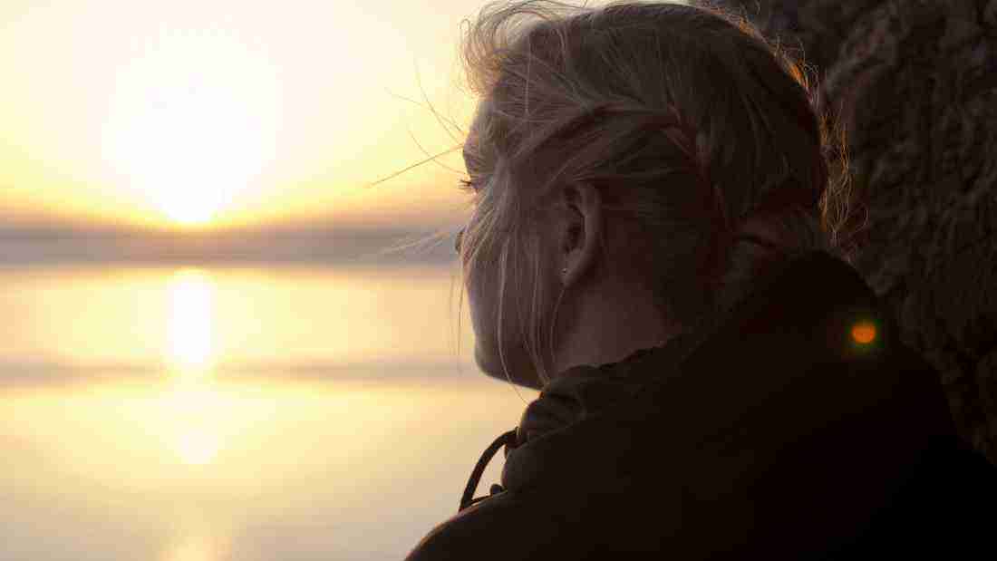 A woman watching the sunset