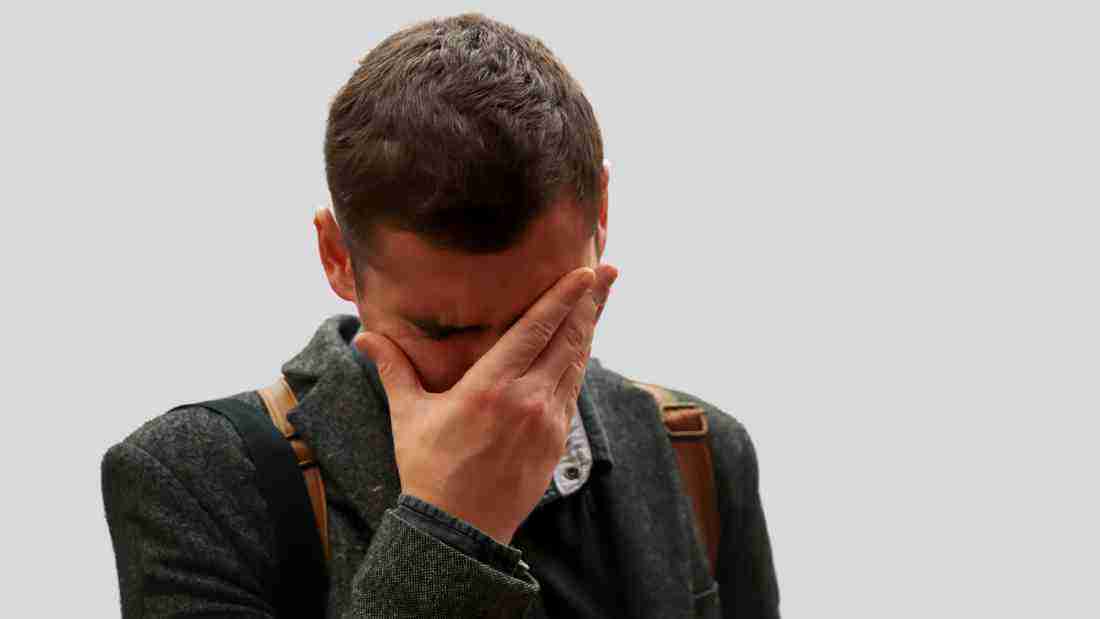 A man who appears to be totally overwhelmed and distressed
