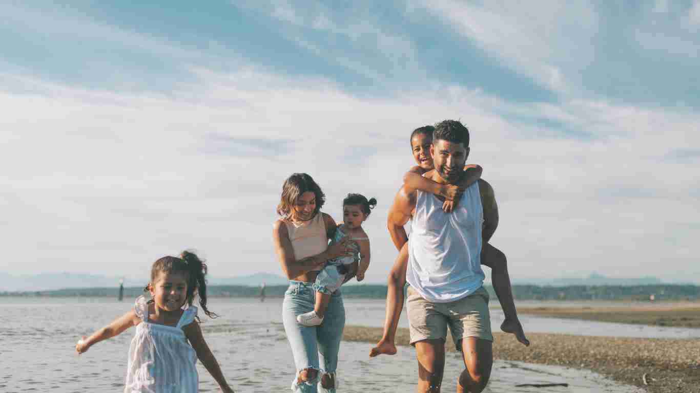 A happy family walking on the beach
