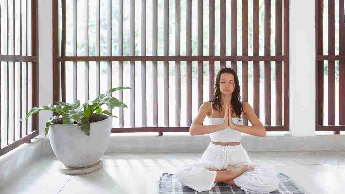 A woman peacefully meditating
