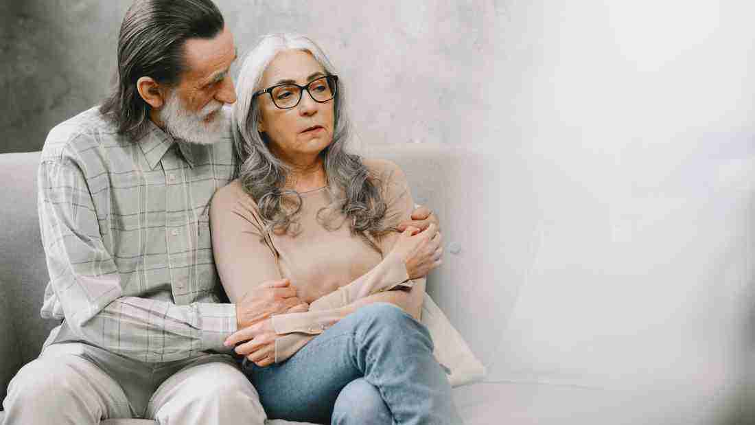 An old couple comforting each other