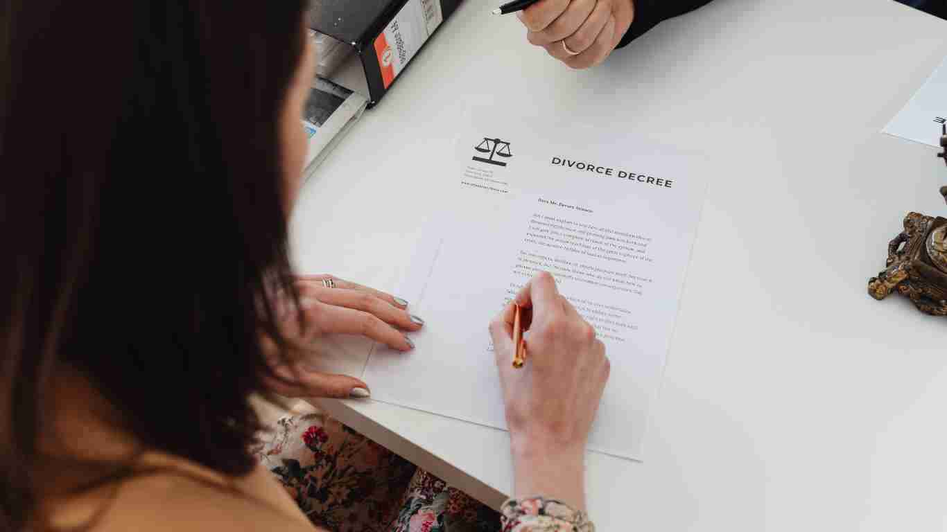 Woman signing divorce agreement