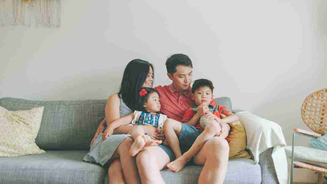 A happy family sitting on the sofa