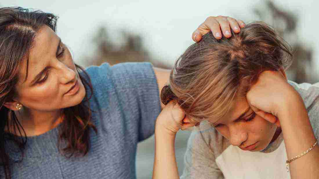 A mother stroking her son's hair