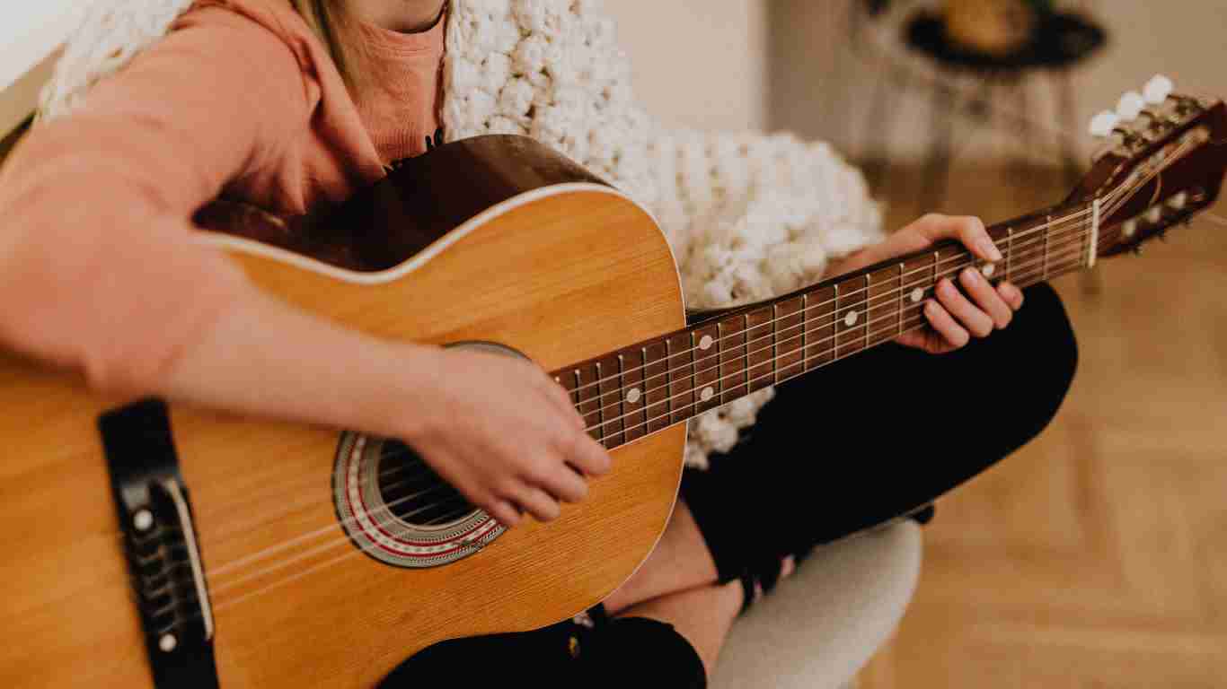 A woman playing the guitar