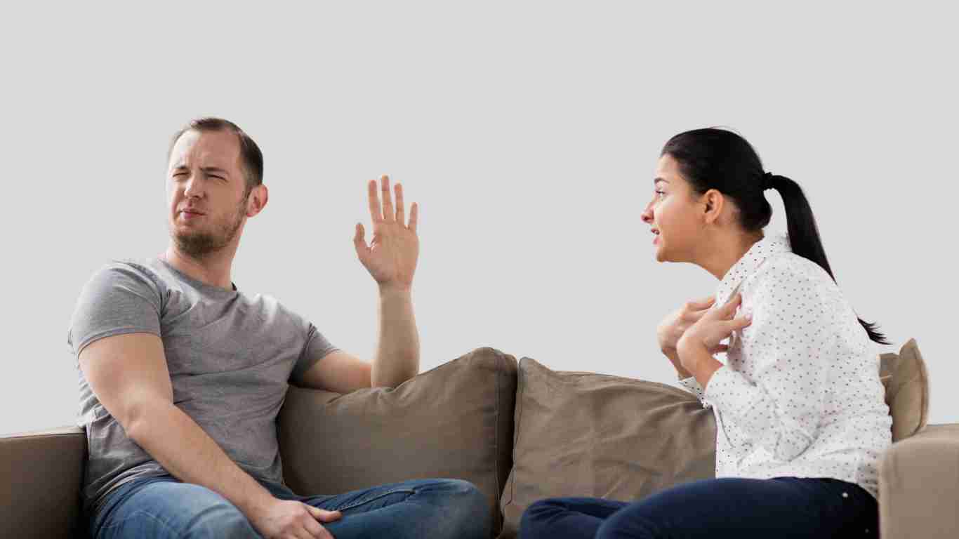 A couple arguing on a sofa