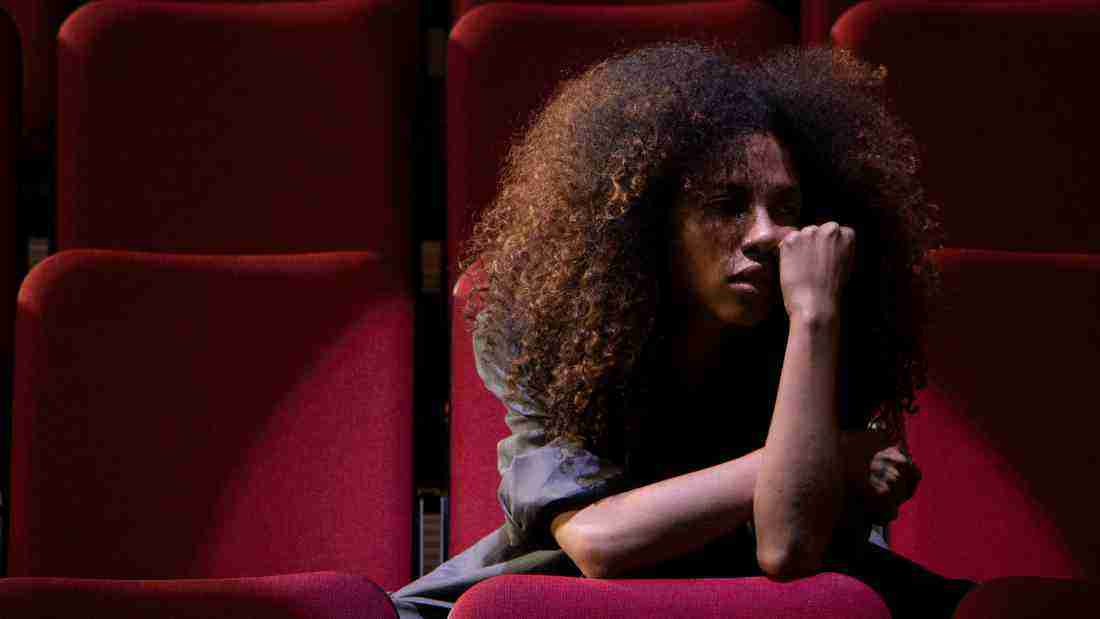 A depressed woman sitting in the dark