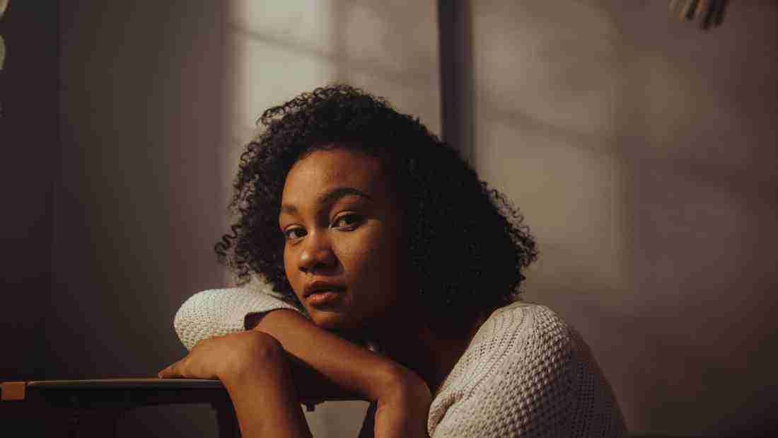 Very anxious woman sitting in the dark