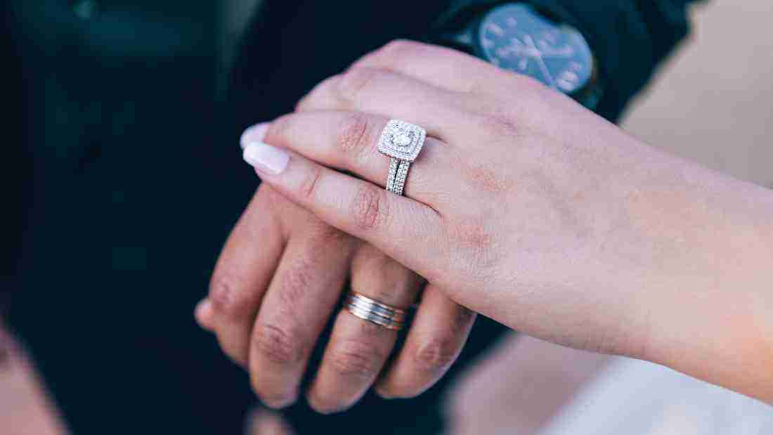 Hands wearing wedding bands