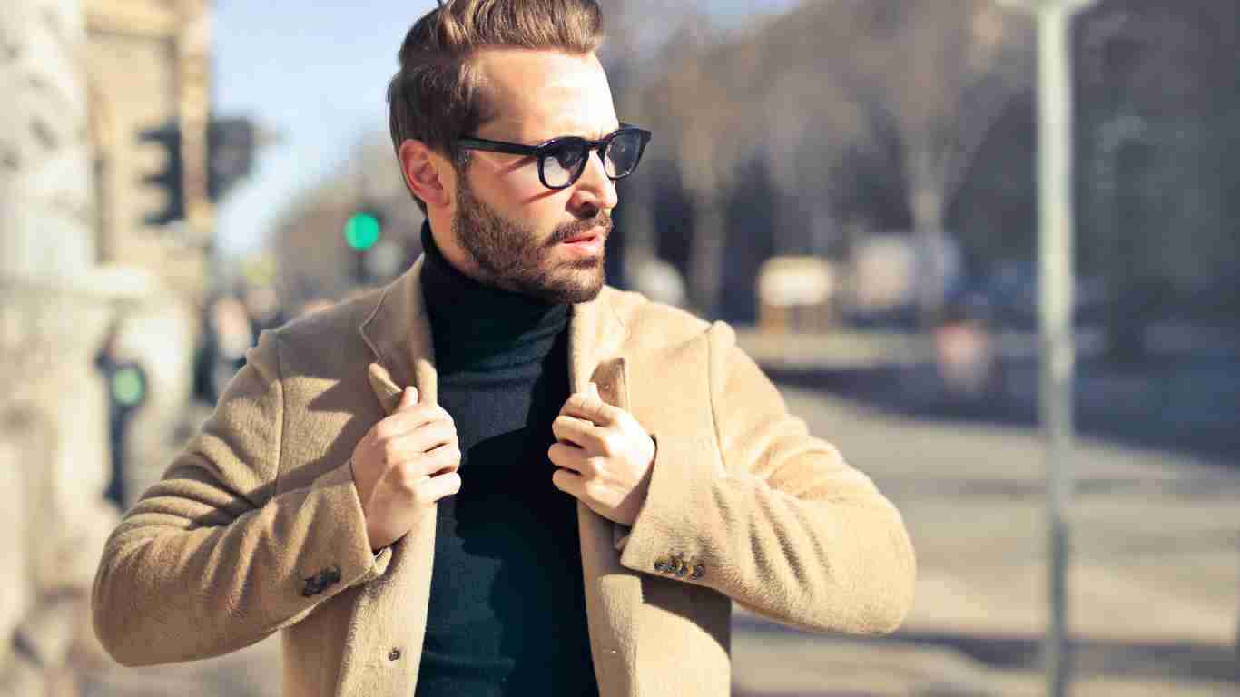 A handsome man wearing a camel coat