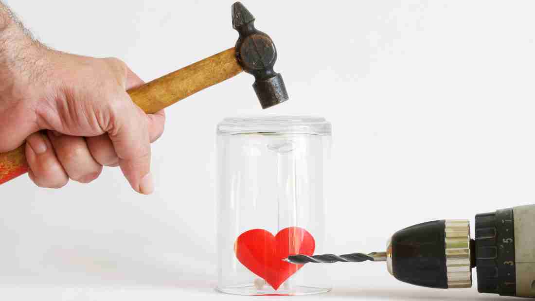 A hammer and a drill trying to hurt a heart, symbolizing the impact of abuse