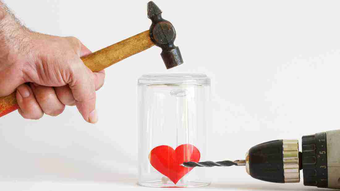 A hammer and a drill trying to hurt a heart, symbolizing the impact of abuse