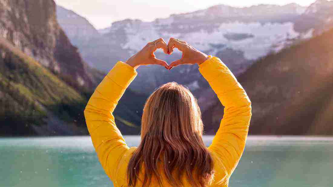 A woman making a heart shape with her hands