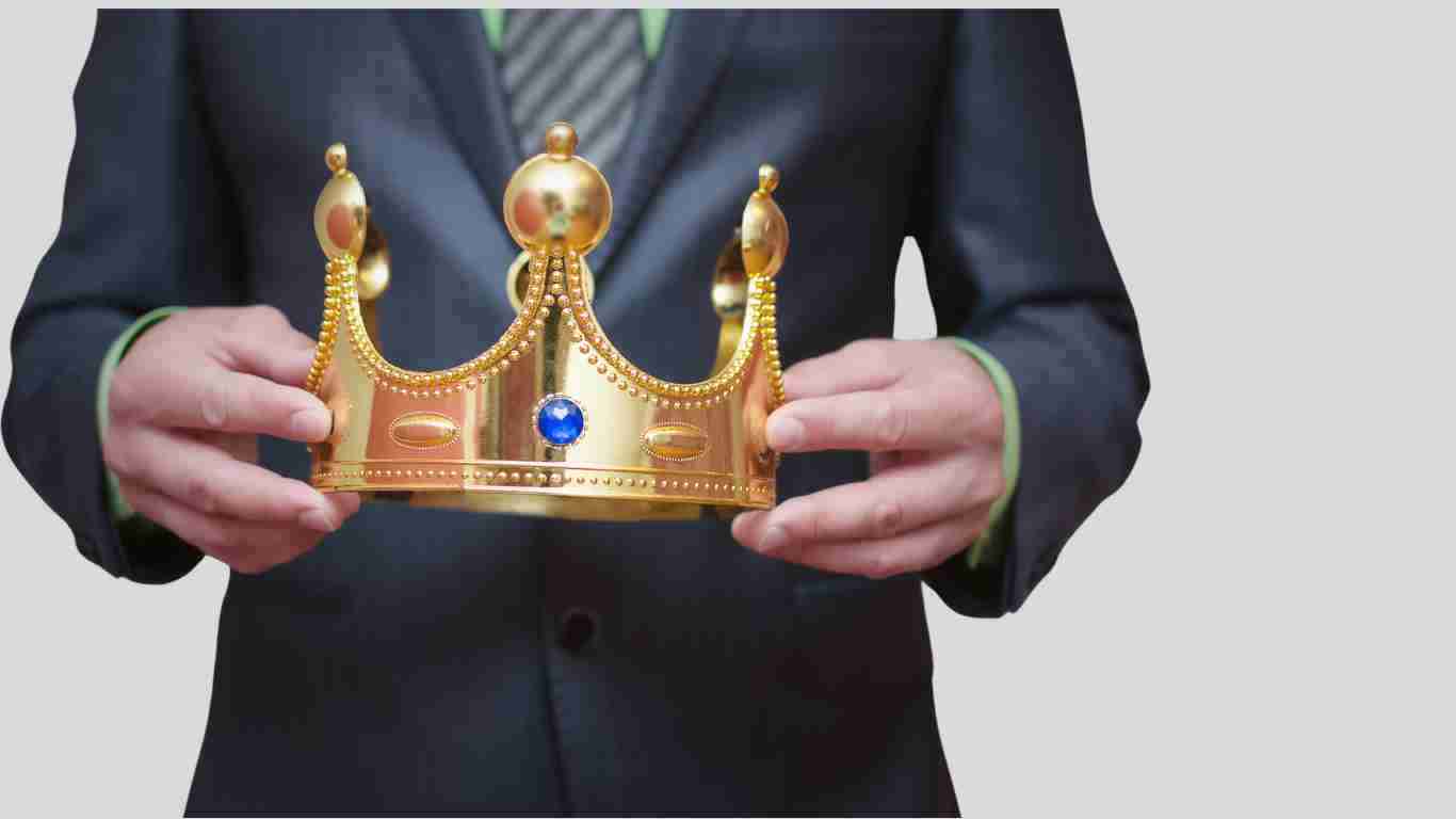 A man holding an ostentatious gold crown