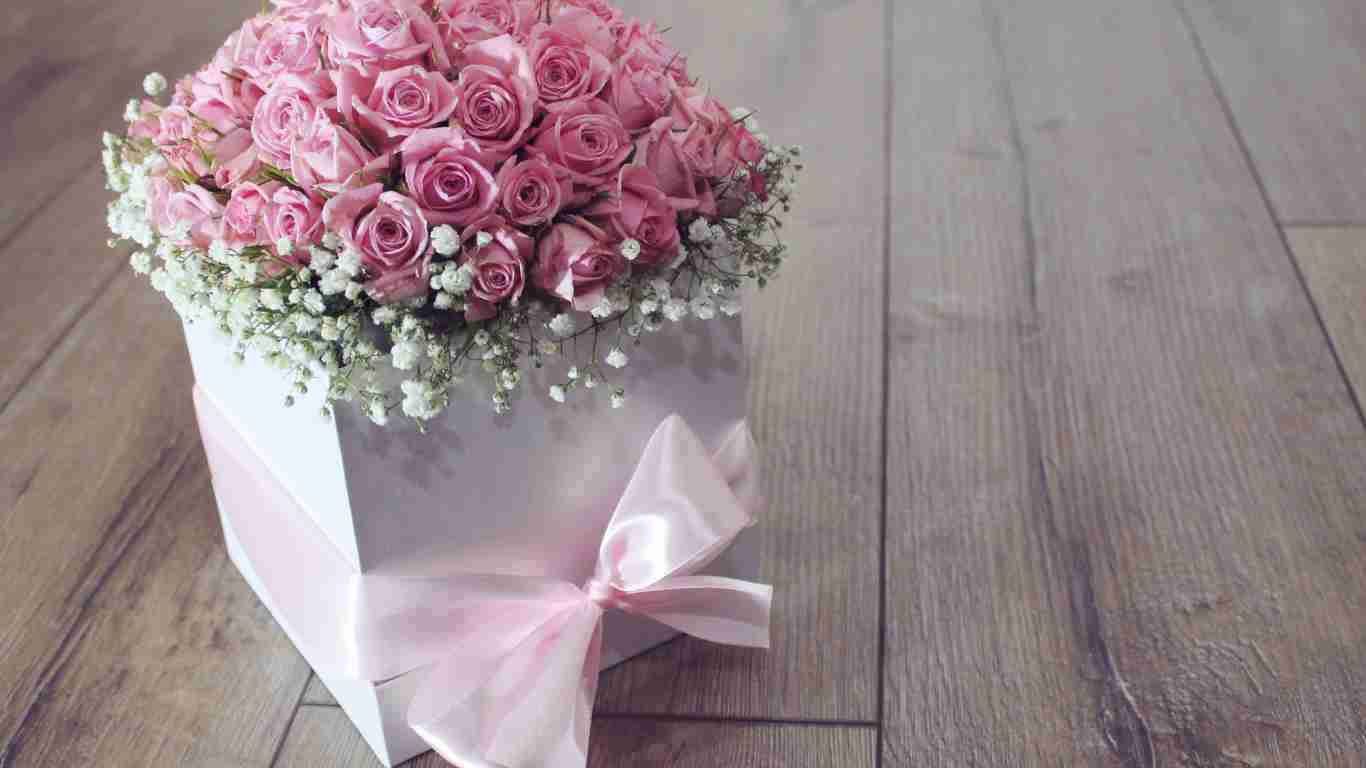 A box full of lovely pink roses, girt wrapped with a big bow