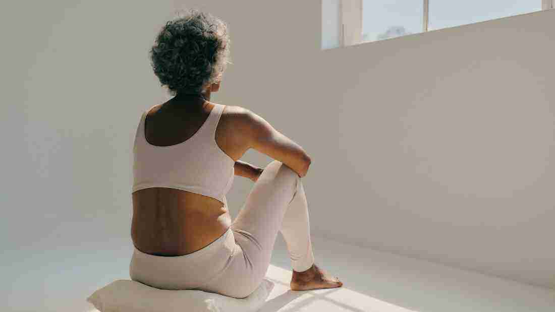 An elderly lady meditating
