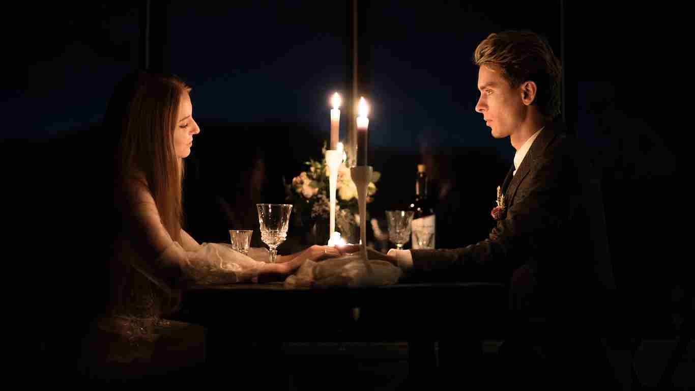 A couple on a romantic candle-lit dinner date