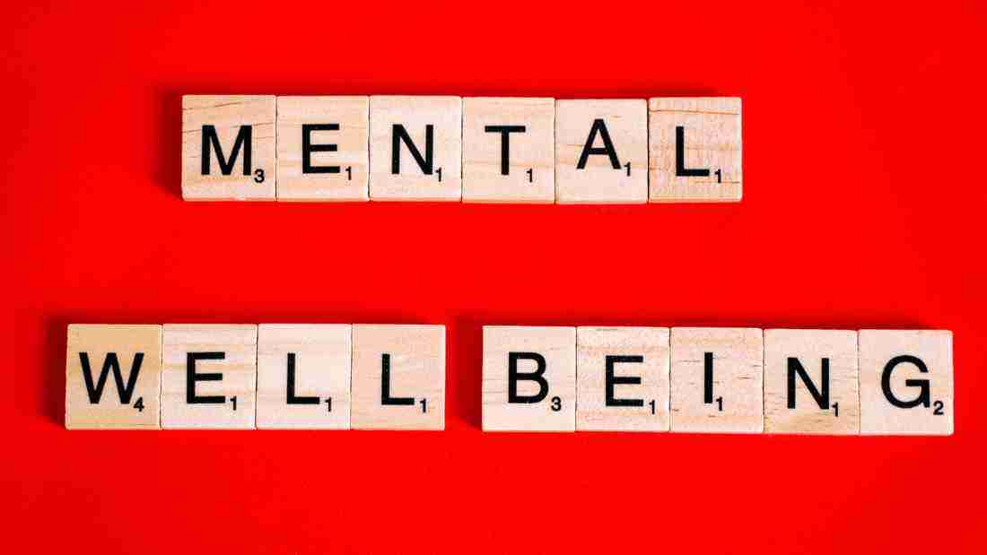 Wooden blocks forming the words MENTAL WELLBEING