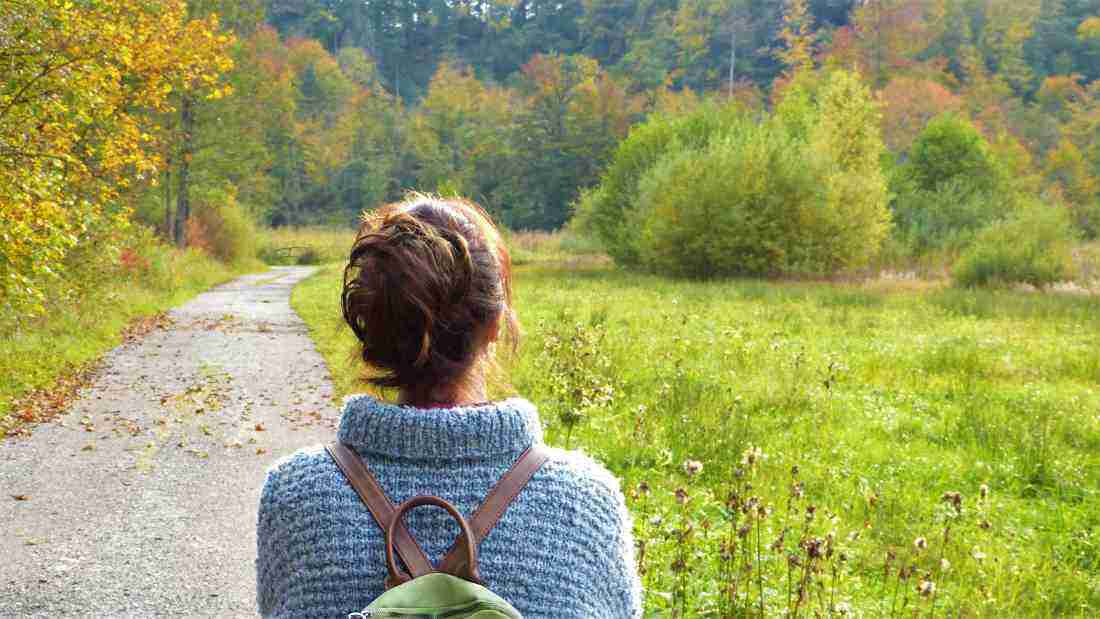 A woman walking alone in a lovely park