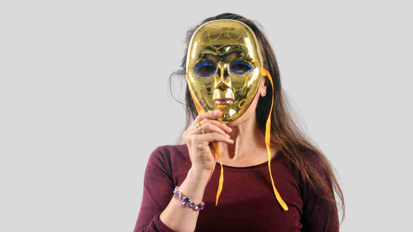 A woman hiding behind a mask