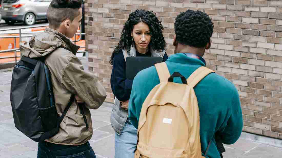 Two young man harassing a young woman