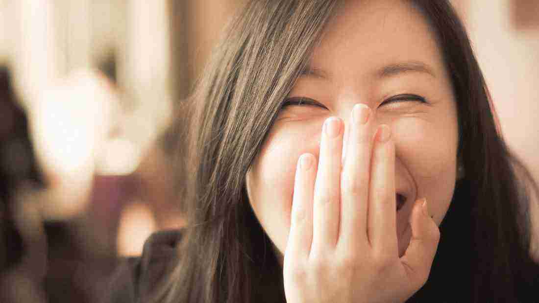 A young woman giggling
