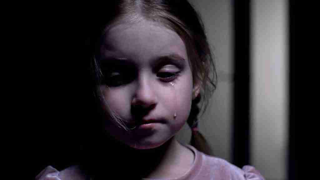 A girl crying in the dark.