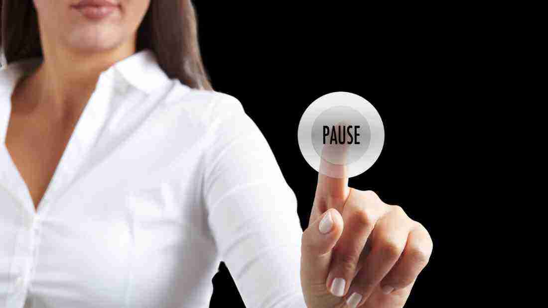 A woman hitting pause